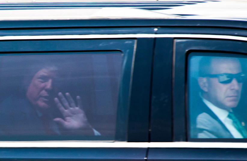 Former U.S. President Donald Trump gestures in a vehicle as he leaves his Mar-a-Lago resort after he was indicted by a Manhattan grand jury following a probe into hush money paid to porn star Stormy Daniels, in Palm Beach, Florida, U.S., April 3, 2023 (credit: REUTERS/MARCO BELLO)