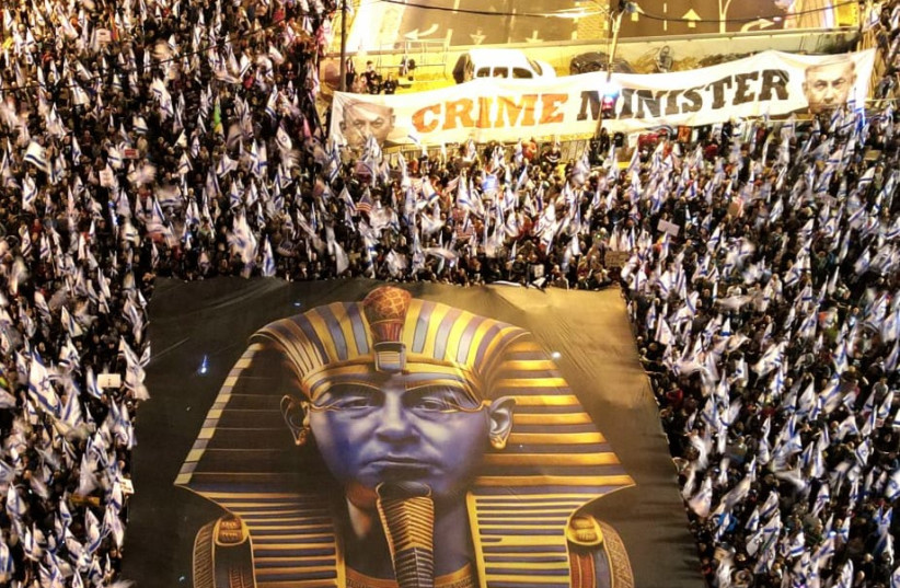 Judicial reform protesters hold a large sign of Prime Minister Benjamin Netanyahu in a pharaoh's outfit on April 8, 2023. (credit: Amir Goldstein)