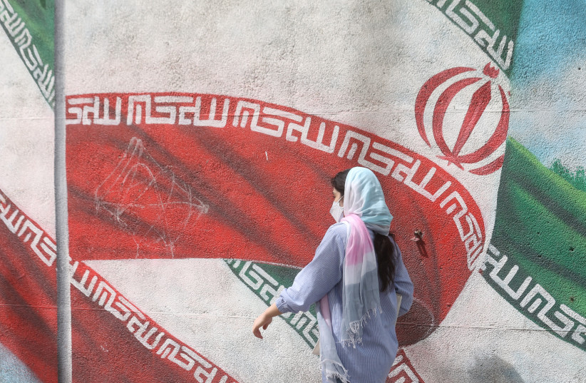  An Iranian woman walks in a street in Tehran, Iran, April 9, 2023 (credit: Majid Asgaripour/WANA/via Reuters)