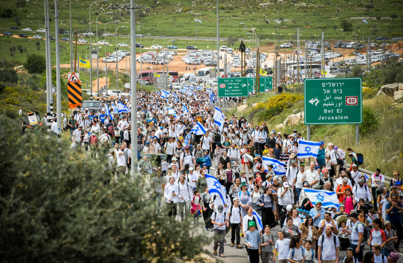  Israeli Jews are seen marching to the Evyatar outspot, near the West Bank city of Nablus, during the Passover holiday, on April 10, 2023. (credit: SRAYA DIAMANT/FLASH90)