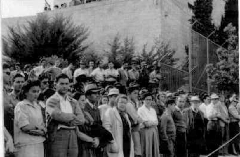  TENS OF THOUSANDS line the streets as the remains of the fallen of Kfar Etzion and others are brought for re-internment on Mount Herzl. (credit: Gush Etzion Heritage Center Archives)