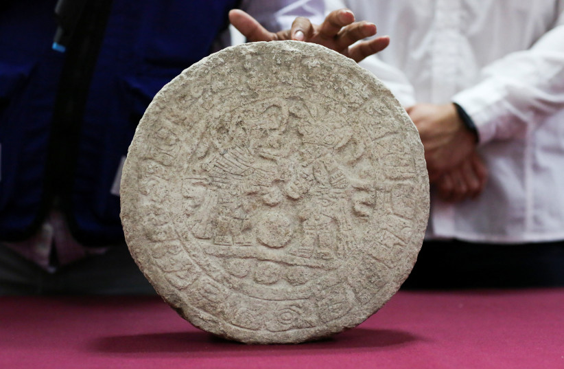  A Mexican archaeologist speaks as he shows a circular-shaped Mayan scoreboard used for a ball game found at Chichen Itza's archaeological site during a news conference, in Merida, Mexico April 11, 2023 (credit: REUTERS/Lorenzo Hernandez)