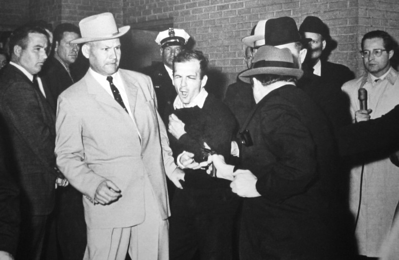  Ruby shooting Oswald, who is being escorted by Dallas police detective Jim Leavelle. (credit: ROBERT H. JACKSON/DALLAS TIMES HERALD/WIKIMEDIA COMMONS)
