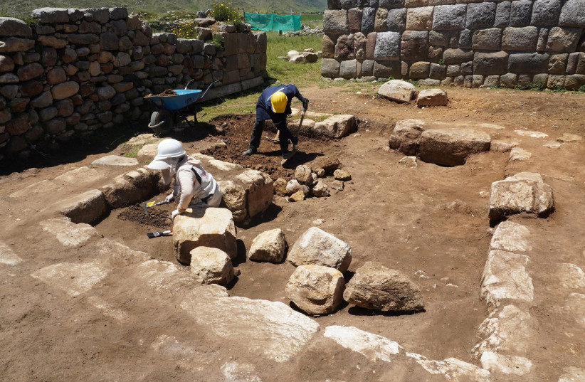 Archaeologists work in the remains of an ancient ceremonial Inca bathroom, discovered in a sector known as Inkawasi (House of the Inca), at the archaeological site Huanuco Pampa, in Huanuco, Peru March 20, 2023. (credit: Peru Culture Ministry/Handout via REUTERS)