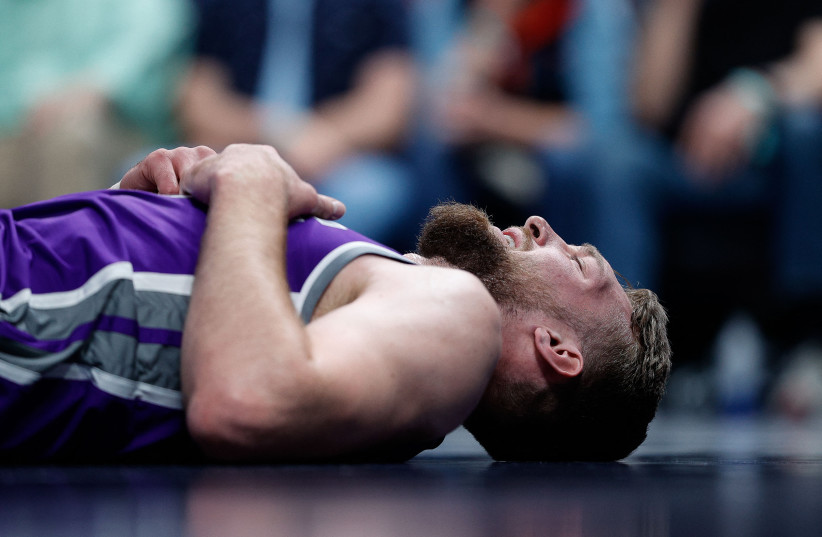  Sacramento Kings forward Domantas Sabonis (10) lies on the court after a play in the first quarter against the Denver Nuggets at Ball Arena. (credit: Isaiah J. Downing-USA TODAY Sports/REUTERS)