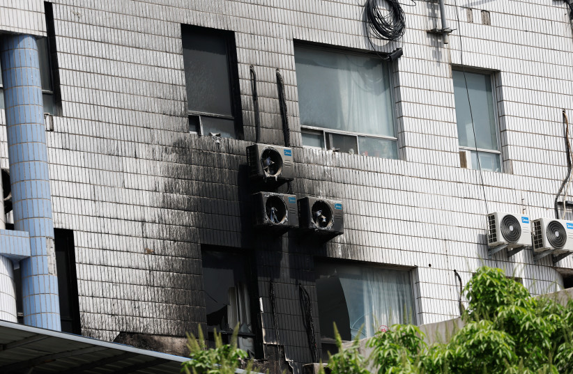  Damaged windows and external air-conditioning fans are seen following a fire that occurred at the Changfeng Hospital, in Beijing, China April 19, 2023 (credit: TINGSHU WANG/REUTERS)
