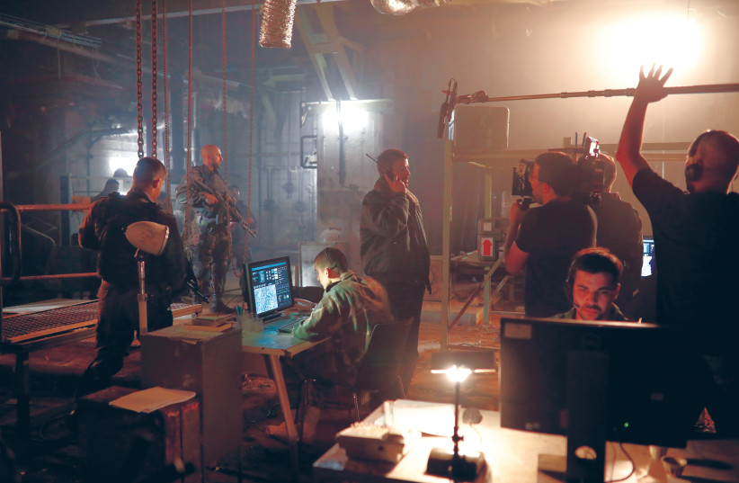  ACTORS AND film crew work on the set of Israeli television series ‘Fauda’ in Tel Aviv in May 2019.  (photo credit: AMIR COHEN/REUTERS)