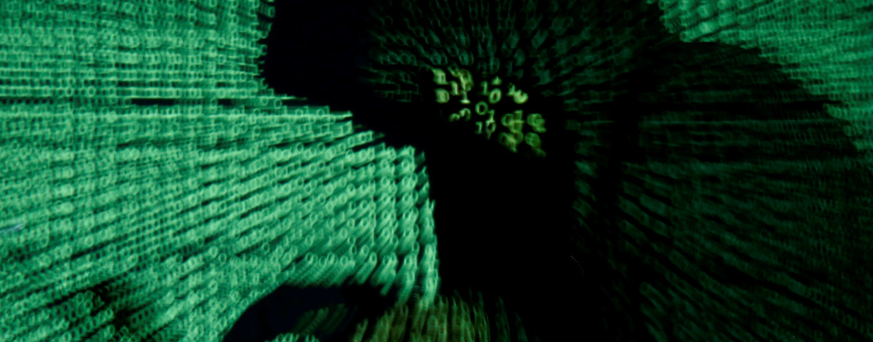  A man holds a laptop computer as cyber code is projected on him in this illustration picture taken on May 13, 2017. 