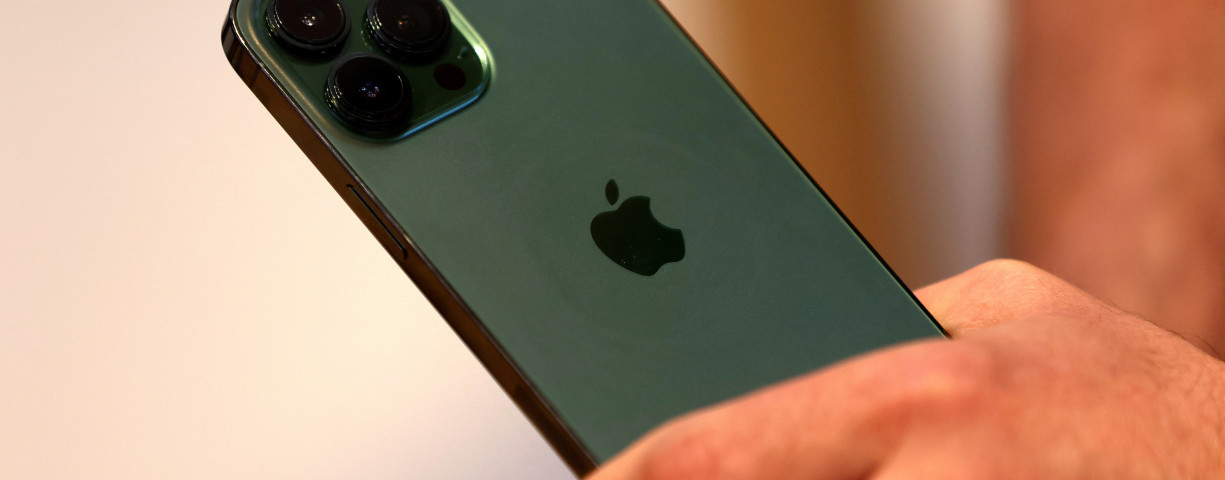  A customers holds the new green colour Apple iPhone 13 pro shortly after it went on sale inside the Apple Store on 5th Avenue in Manhattan in New York City, New York, US, March 18, 2022.