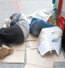 Homeless people sleeping on the sidewalk.