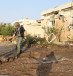 Police bomb disposal experts examine the scene after a rocket directly hit a home in the southern city of Ashkelon 