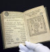 A 16th-century edition of predictions by Nostradamus, the first book to be digitised by Google from a collection of 500,000 at the Municipal Library of Lyon, is displayed by a librarian in this January 15, 2010 file picture. Amid the flat, wide fields of central France, a team of re-trained secretar