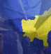 People are pictured through Kosovo flag as they take part in celebrations of the 10th anniversary of Kosovo's independence in Pristina, Kosovo February 17, 2018