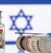  Vials containing the corona vaccine and a syringe are displayed in front of an Israeli flag.