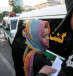 Morality police take down the name of a detained woman during a crackdown on "social corruption" in north Tehran, June 18, 2008.