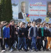  High school students, who are potential conscripts, walk under the portraits of Russian President Vladimir Putin (L) and Defence Minister Sergei Shoigu during an open army day at a military base in Stavropol
