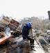  A person reacts while sitting on the rubble of a collapsed building, in the aftermath of an earthquake, in Kahramanmaras, Turkey, February 9, 2023