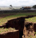  A tanker drives near a chasm suspected to have been caused by a heavy downpour along an underground fault-line near the Rift Valley town of Mai-Mahiu.