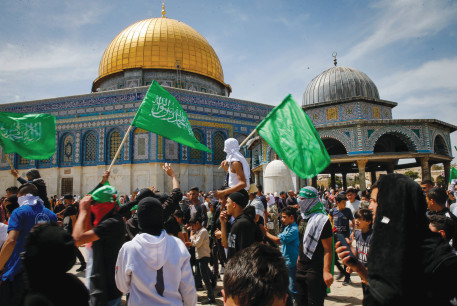  WAVING HAMAS flags after Ramadan prayers on the Temple Mount in Jerusalem, April 22. Occupationalists seems to side with Hamas and not with peaceful Muslim worshipers.