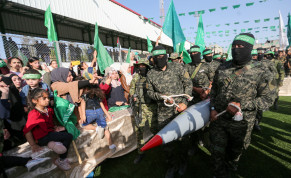 Palestinian Hamas militants carry a rocket as they parade during an anti-Israel rally in Rafah, in the southern Gaza Strip