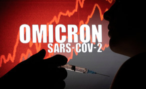  People pose with syringe with needle in front of displayed words "OMICRON SARS-COV-2" in this illustration taken, December 11, 2021