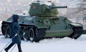  A woman passes by a T-34 tank and other Soviet-era military vehicles while practising nordic walking in a park in the rebel-held city of Donetsk, Ukraine January 27, 2022.