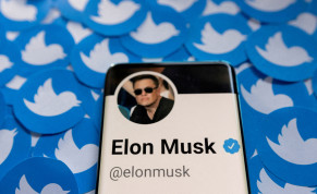  Elon Musk's Twitter profile is seen on a smartphone placed on printed Twitter logos in this picture illustration taken April 28, 2022
