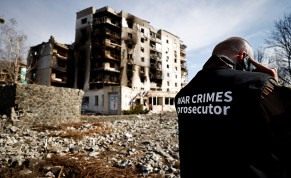  War crime prosecutor's team member speaks on the phone next to buildings that were destroyed by Russian shelling, amid Russia's Invasion of Ukraine, in Borodyanka, Kyiv region, Ukraine April 7, 2022