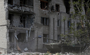  A Russian infantry fighting vehicle is seen in front of an apartment building heavily damaged during Ukraine-Russia conflict in the town of Popasna in the Luhansk Region, Ukraine May 26, 2022