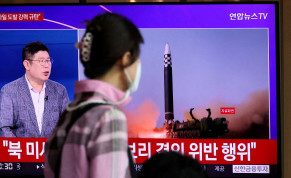 A woman watches a TV broadcasting a news report on North Korea's launch of three missiles including one thought to be an intercontinental ballistic missile (ICBM), in Seoul, South Korea, May 25, 2022.