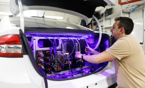  A worker tends to systems in the back of a Mobileye autonomous driving test vehicle, at the Mobileye headquarters in Jerusalem