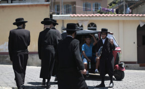  Members of a Jewish community walk near a motor taxi in the village of San Juan La Laguna August 24, 2014.