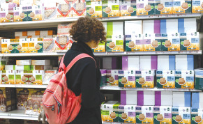  A WOMAN examines the influx of matzah boxes in a supermarket on Wednesday in Jerusalem ahead of the Passover holiday. 