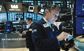  TRADERS WORK on the floor of the New York Stock Exchange (NYSE) on Tuesday in New York City.