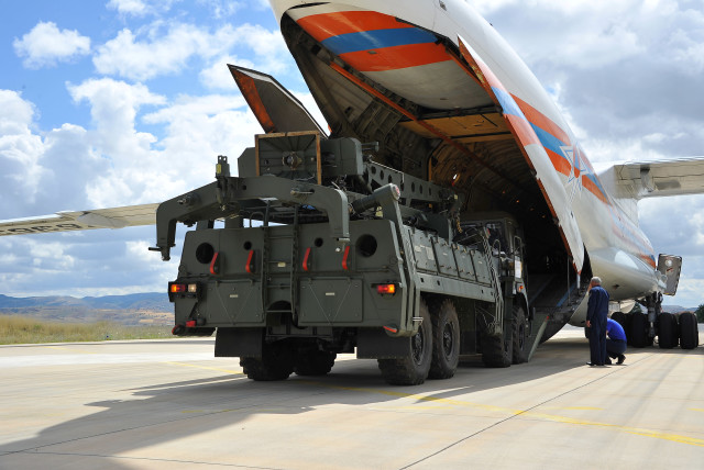 First parts of a Russian S-400 missile defense system are unloaded from a Russian plane at Murted Airport, known as Akinci Air Base, near Ankara, Turkey, July 12, 2019. (photo credit: REUTERS)