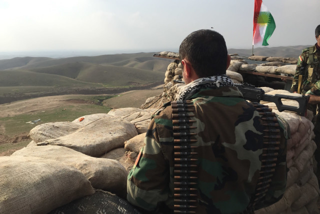 A Kurdistan Region Peshmerga looks out at ISIS positions from his frontline near Kirkuk in 2015 (photo credit: SETH J. FRANTZMAN)