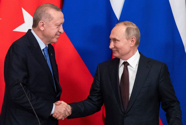 Russian President Vladimir Putin and Turkish President Tayyip Erdogan shake hands during a news conference following their talks in Moscow, Russia March 5, 2020.  (photo credit: PAVEL GOLOVKIN/POOL VIA REUTERS)