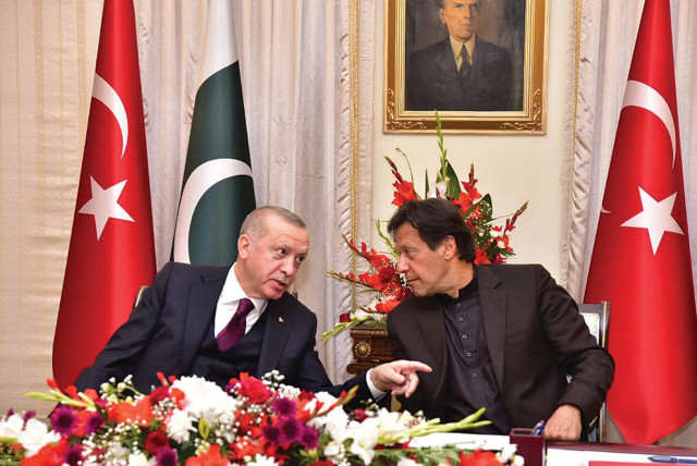 PAKISTAN’S PRIME MINISTER Imran Khan (right) and Turkish President Tayyip Erdogan speak during an agreement signing ceremony in Islamabad, in February. (photo credit: REUTERS)