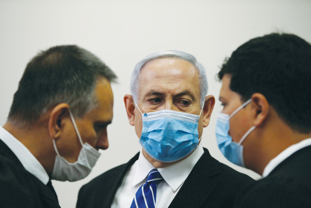 PRIME MINISTER Benjamin Netanyahu with members of his legal team at the beginning of his corruption trial at the Jerusalem District Court in May. (photo credit: RONEN ZVULUN/REUTERS)