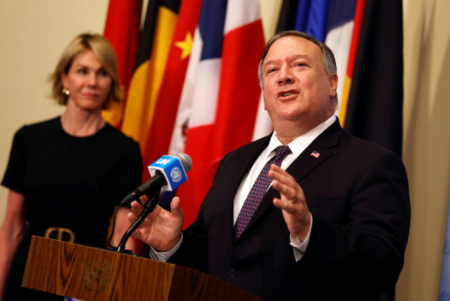 U.S. Secretary of State Mike Pompeo speaks to reporters following a meeting with members of the U.N. Security Council about Iran's alleged non-compliance with a nuclear deal and calling for the restoration of sanctions against Iran as U.S. Ambassador to the United Nations Kelly Craft listens at U.N. (photo credit: REUTERS/MIKE SEGAR/POOL)
