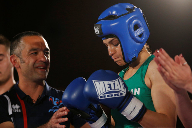 Iranian boxer Sadaf Khadem and coach Mahyar Monshipour react before the fight against French boxer Anne Chauvin during an official boxing bout in Royan, France, April 13, 2019