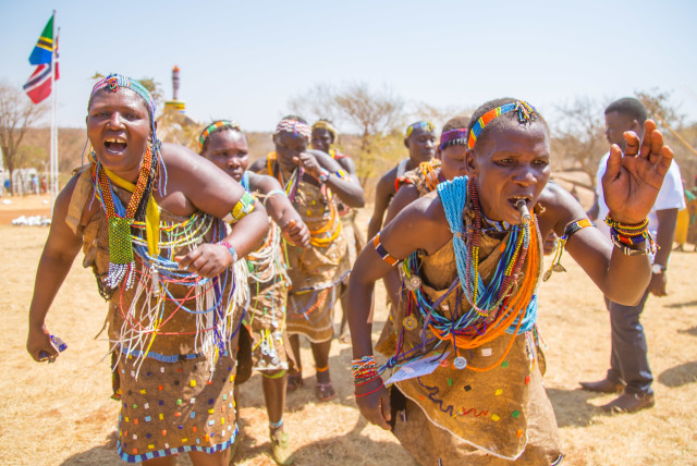  Members of the Hadza, a modern hunter-gatherer people living in northern Tanzania, singing and dancing