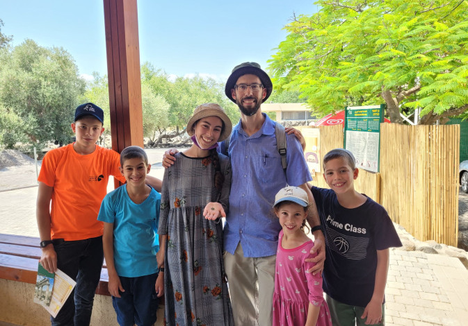 The Yitzhaki family with the ancient coin from 1500 years ago that was found at Korazim National Park (DEKEL SEGEV/NATURE AND PARKS AUTHORITY).