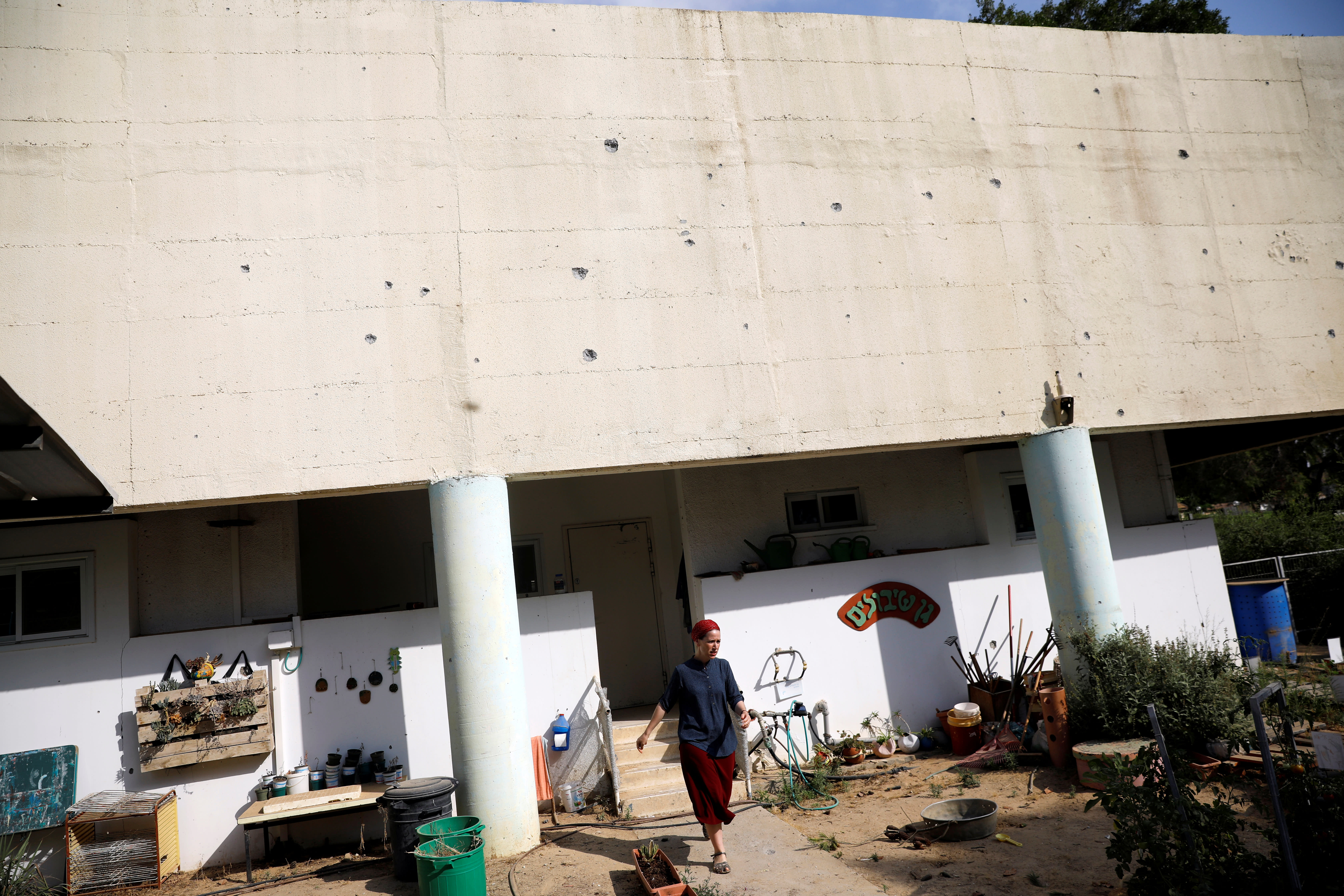 Damages caused by mortar shells fired from the Gaza Strip that landed near a kindergarten can be seen on its wall, in a Kibbutz on the Israeli side of the Israeli-Gaza border May 29, 2018 (Reuters)