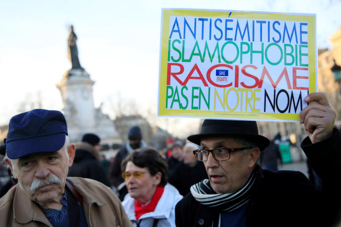People attend a national gathering to protest antisemitism and the rise of antisemitic attacks in the Place de la Republique in Paris, France, February 19, 2019. The writing on the sign reads: 