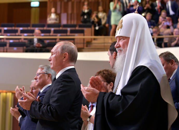 Russian President Putin and Patriarch Kirill applaud during the inaugural ceremony of Moscow Mayor Sergei Sobyanin at the Zaryadye Concert Hall in Moscow (Credit: REUTERS)