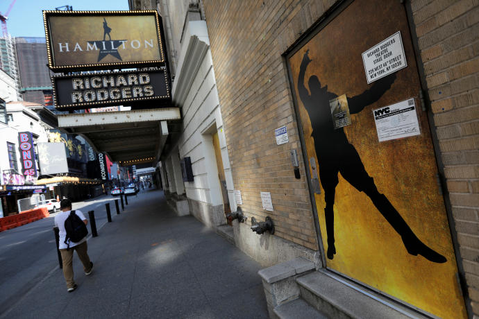 A man walks past the shuttered Richard Rodgers Theatre, home of the popular musical "Hamilton" after industry group the Broadway League said Broadway theaters will remain closed through January 3, 2021, in New York, U.S., July 2, 2020REUTERS/MIKE SEGAR