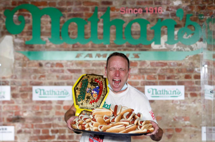 Joey Chestnut poses after winning the Nathan's Famous Fourth of July International Hot Dog Eating Contest with a world record 75 hot dogs consumed in Brooklyn, in New York City, U.S., July 4, 2020ANDREW KELLY / REUTERS