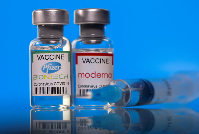 Vials with Pfizer-BioNTech and Moderna coronavirus disease (COVID-19) vaccine labels are seen in this illustration picture taken March 19, 2021.REUTERS/DADO RUVIC/ILLUSTRATION/FILE PHOTO