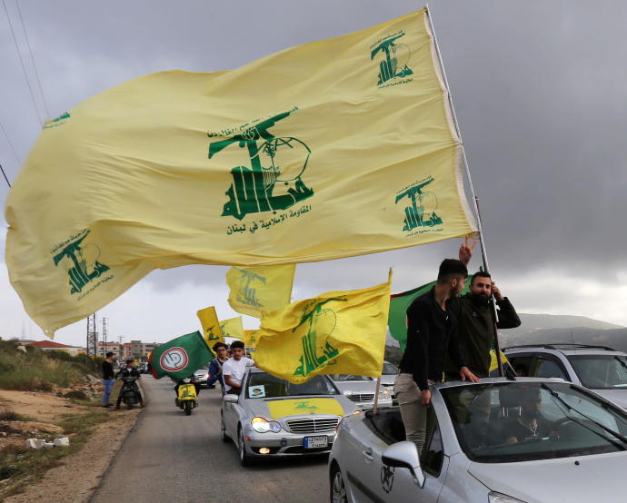 WAVING THE Hezbollah flag in Marjayoun, Lebanon.AZIZ TAHER/REUTERS